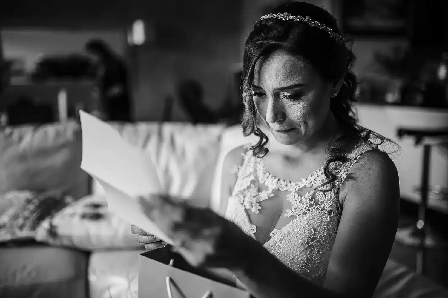 Emotional Bride reading a letter from the groom with a special gift he gave her to wear at the wedding during the final moments of her getting ready | Costa Rica Wedding Photographer