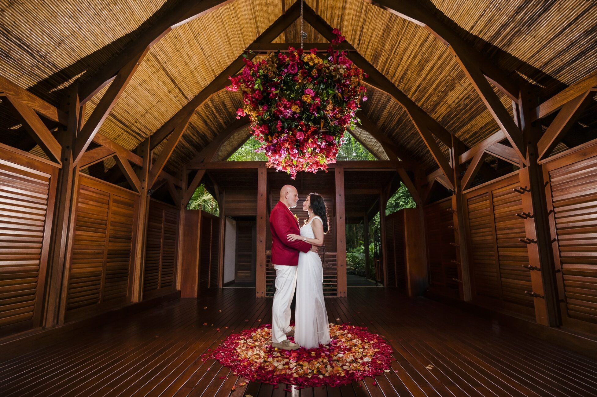 Portrait of the bride and groom at Amor Arenal during their wedding ceremony at the yoga facility of the hotel.